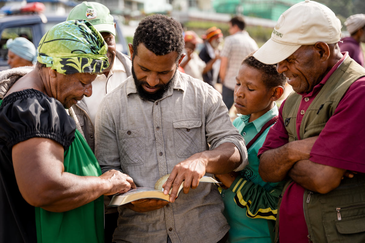 People reading through the newly translated Enga New Testament.